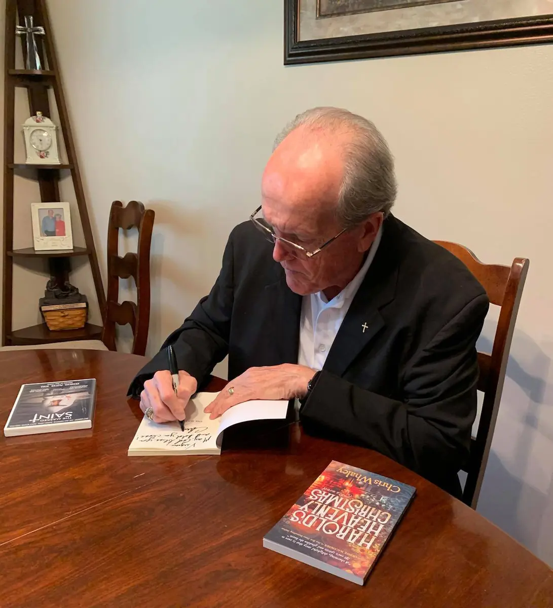 Chris Whaley signing a copy of one of his books