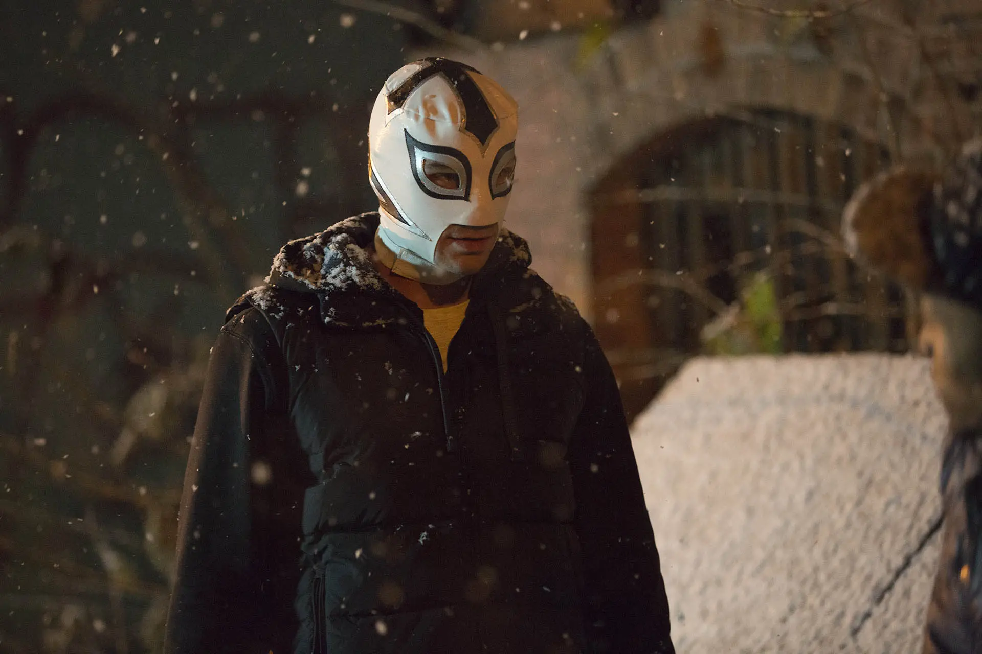 The masked hero from The Masked Saint standing in falling snow